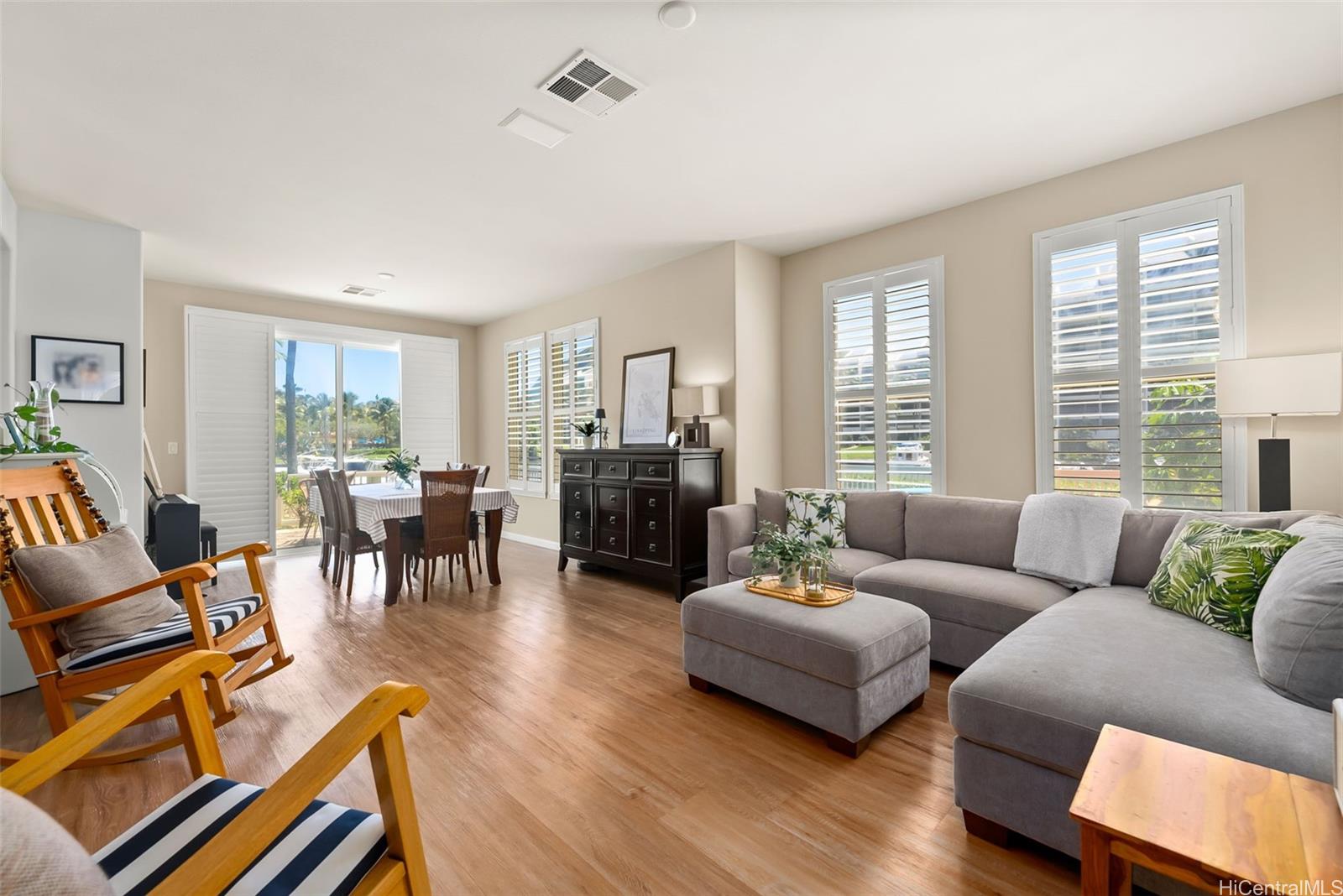 520 Lunalilo Home Road, Unit 310 Honolulu, HI 96825 - Photo 4 of 23 Living and dining area with high ceilings, plantation shutters and direct access to the backyard