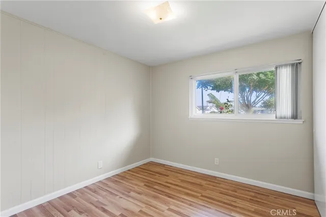 a view of a room with wooden floor and window