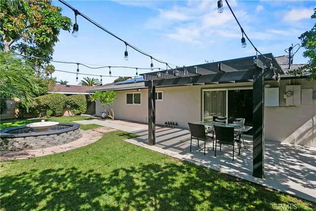 a view of a patio with table and chairs under an umbrella