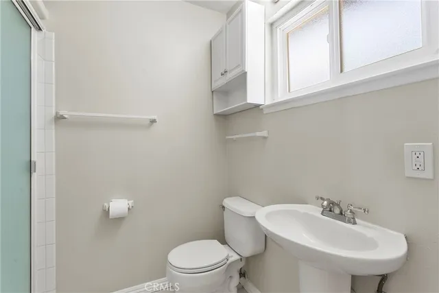 a bathroom with a sink a mirror and a toilet