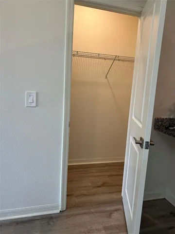 a view of small space with racks on the wall and a window