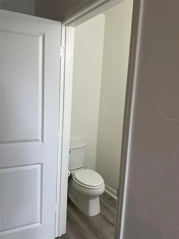 a white toilet sitting next to a shower
