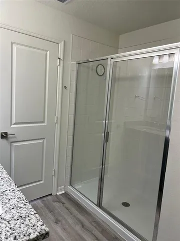 a bathroom with a glass shower door