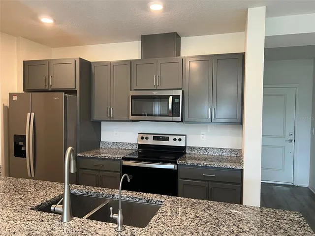 a kitchen with a refrigerator sink and microwave