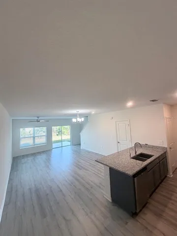 a living room with hard wood floors and a wooden floor