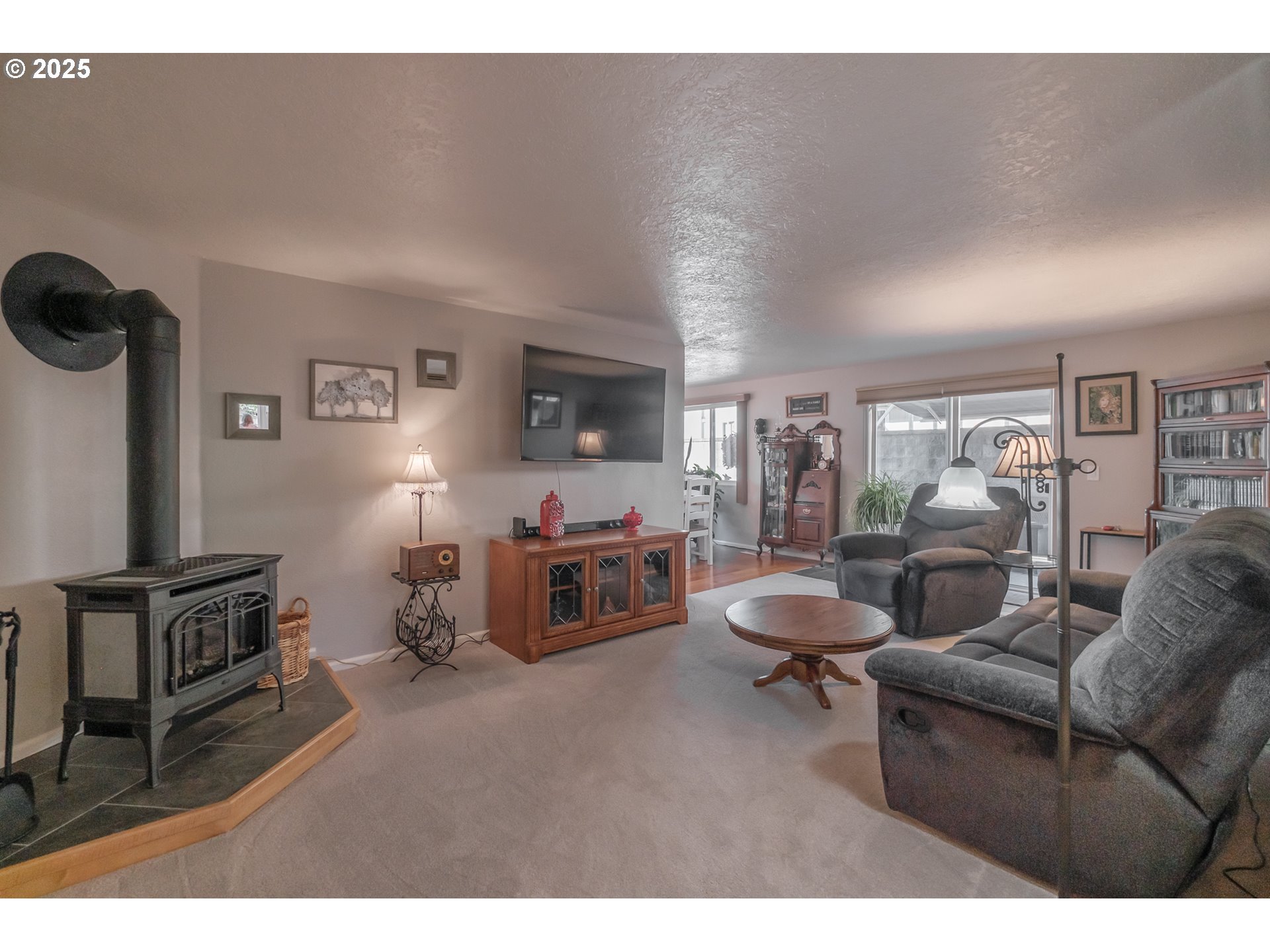 2669 Southeast Chicago Street Albany, OR 97322 - Photo 3 of 31 a living room with furniture a flat screen tv and a table