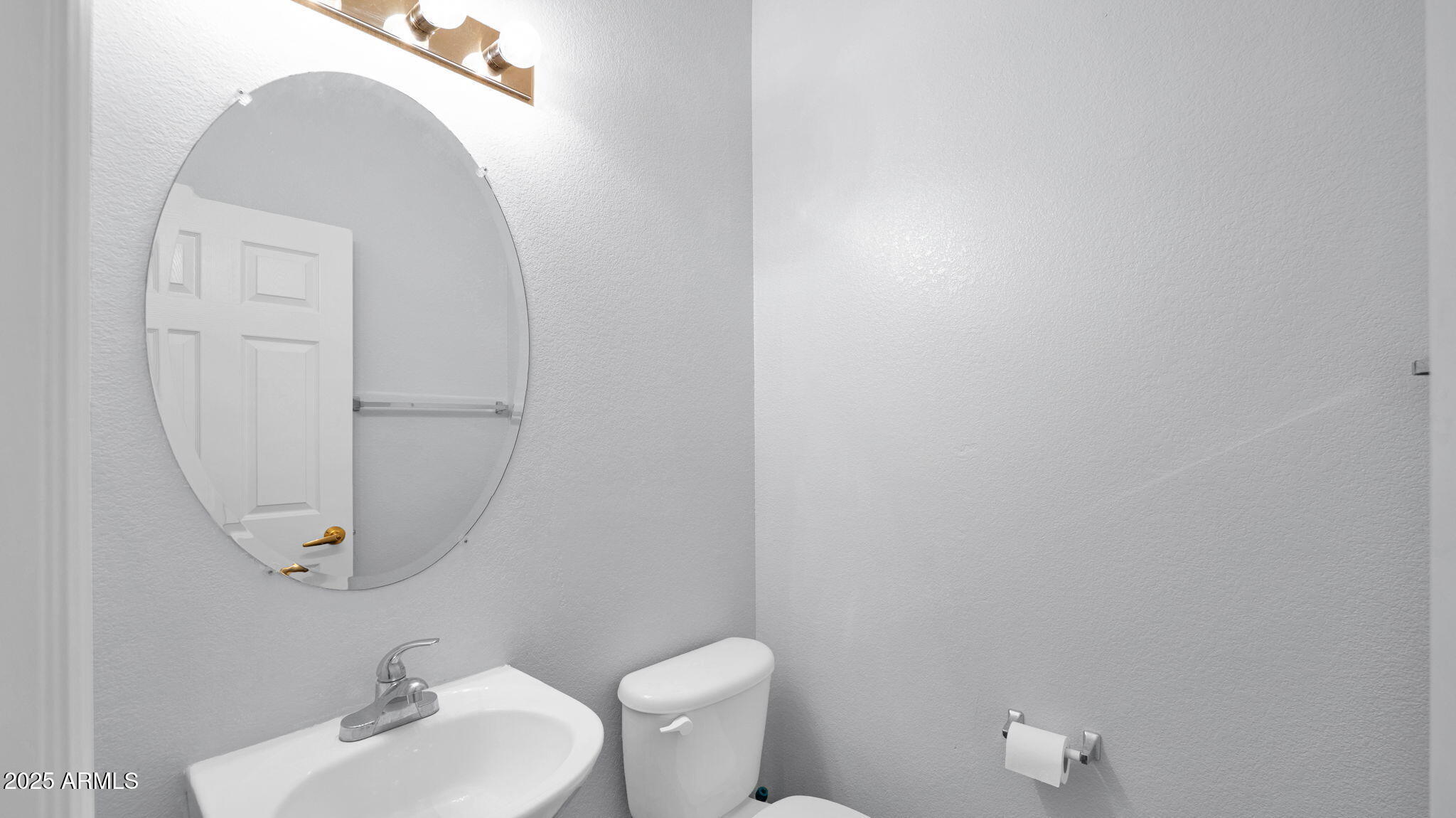 1702 East Bell Road, Unit 113 Phoenix, AZ 85022 - Photo 12 of 32 a bathroom with a toilet sink and mirror