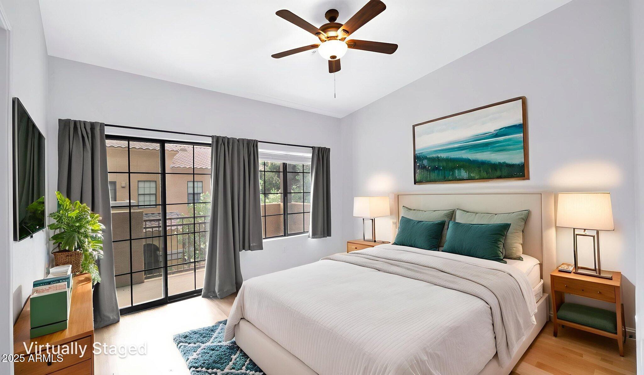 1702 East Bell Road, Unit 113 Phoenix, AZ 85022 - Photo 15 of 32 a bedroom with a large bed and a chandelier fan