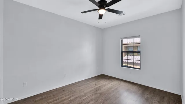 a bedroom with a large bed and a flat screen tv