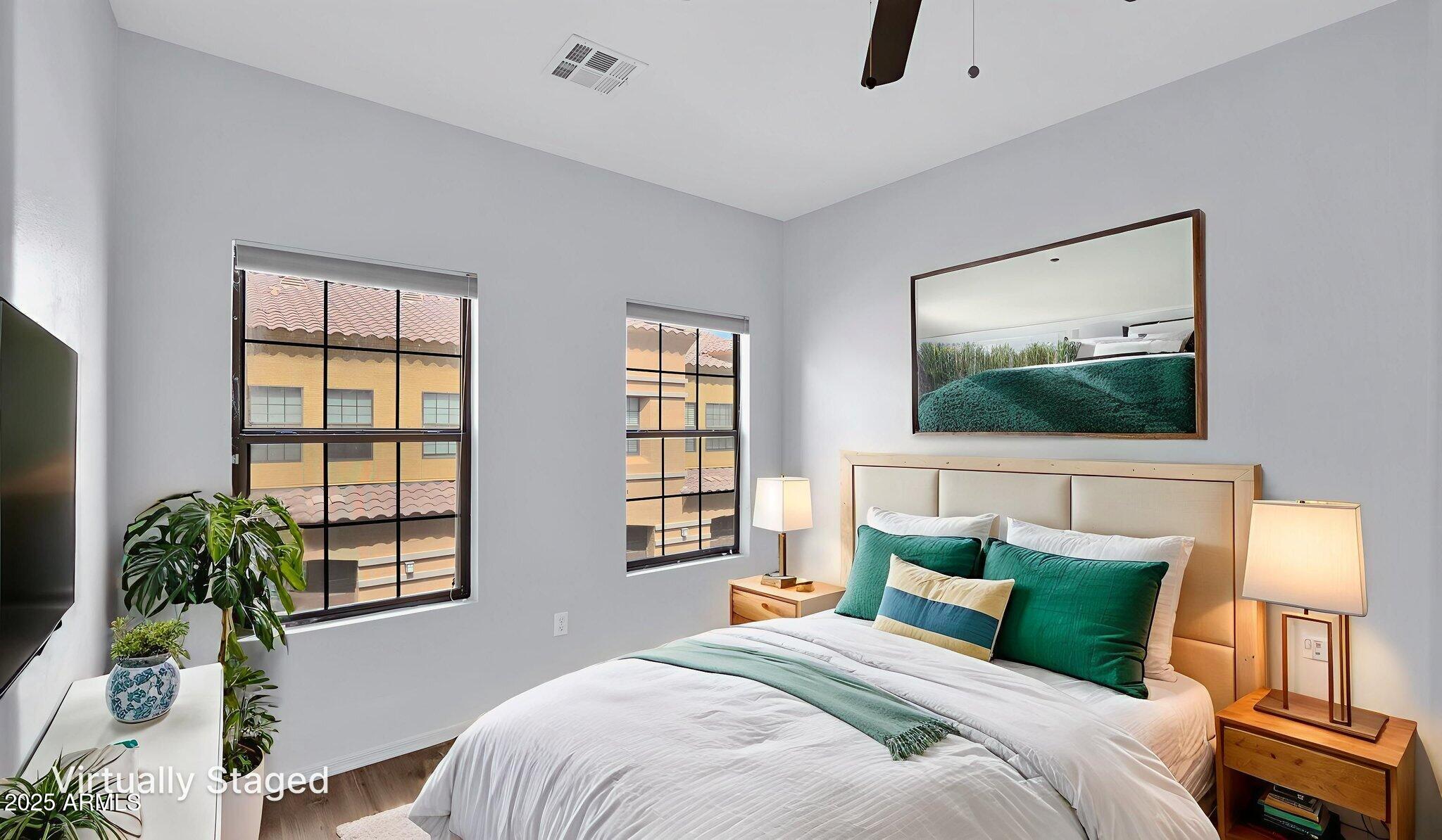 1702 East Bell Road, Unit 113 Phoenix, AZ 85022 - Photo 25 of 32 a bedroom with a large bed and a flat screen tv