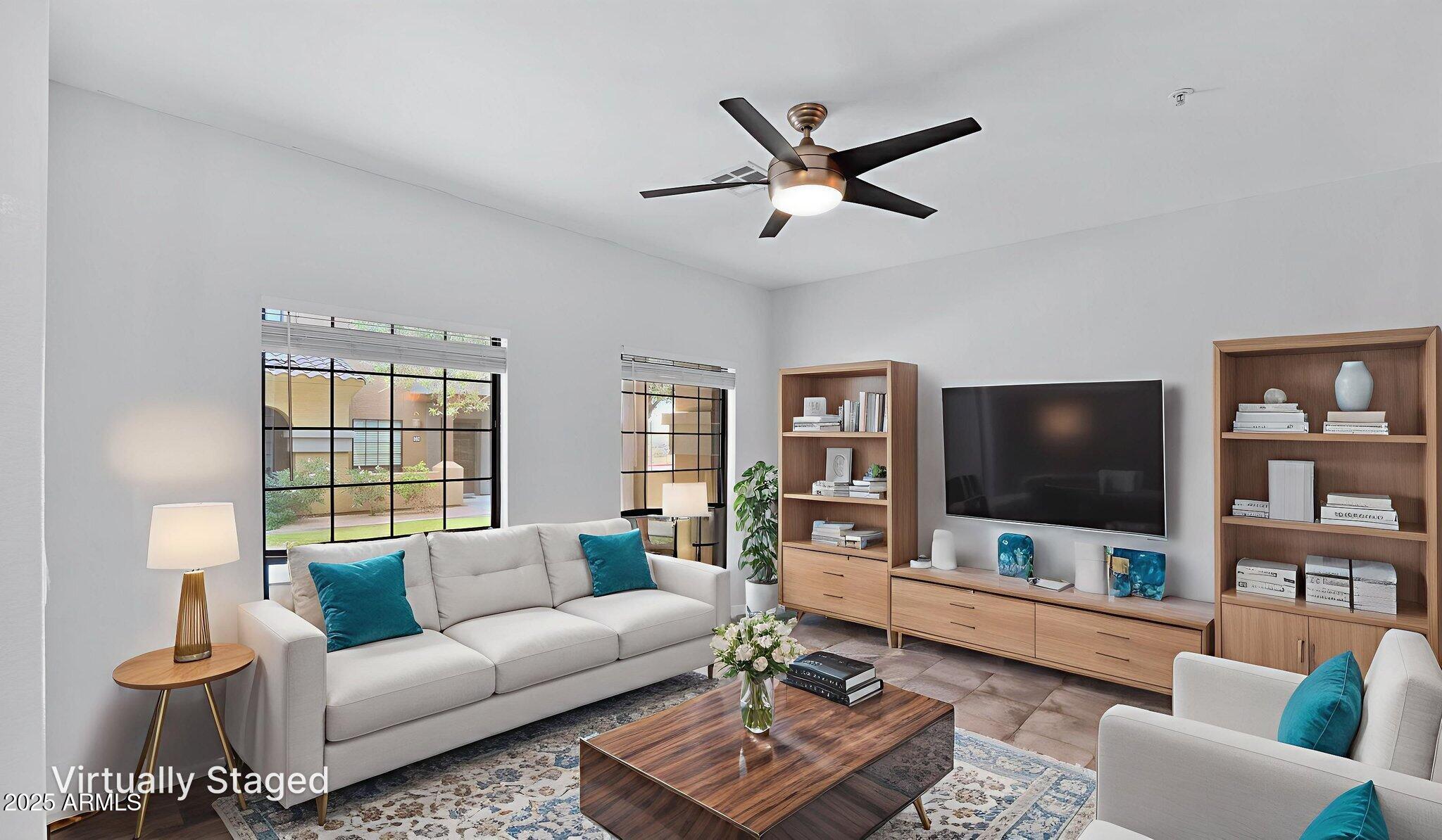 1702 East Bell Road, Unit 113 Phoenix, AZ 85022 - Photo 3 of 32 a living room with furniture and a flat screen tv