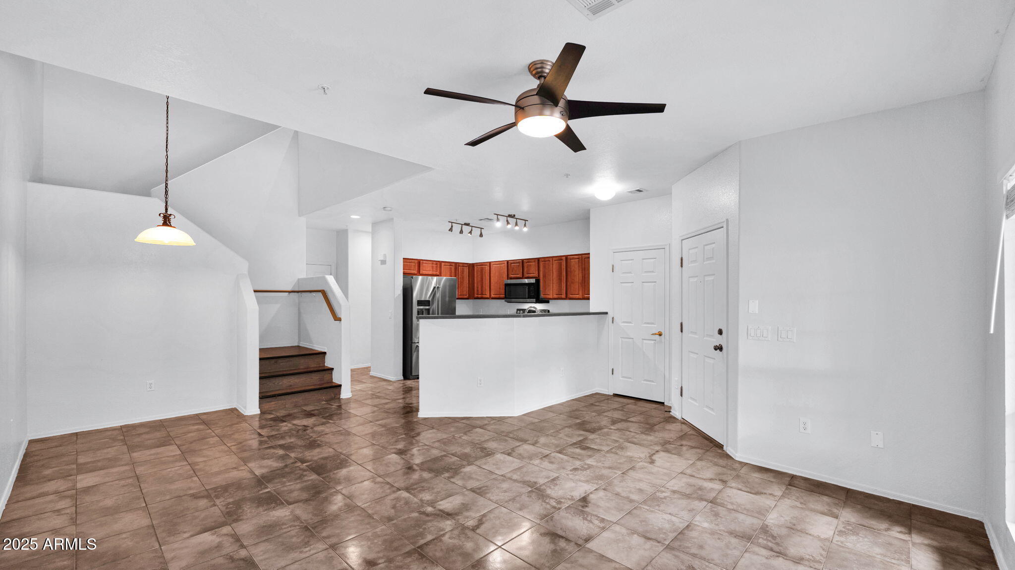 1702 East Bell Road, Unit 113 Phoenix, AZ 85022 - Photo 6 of 32 a view of a livingroom with a ceiling fan and window
