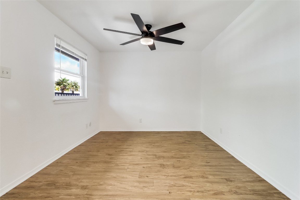 2401 Manor Road, Unit 210 Austin, TX 78722 - Photo 13 of 20 an empty room with window and ceiling fan