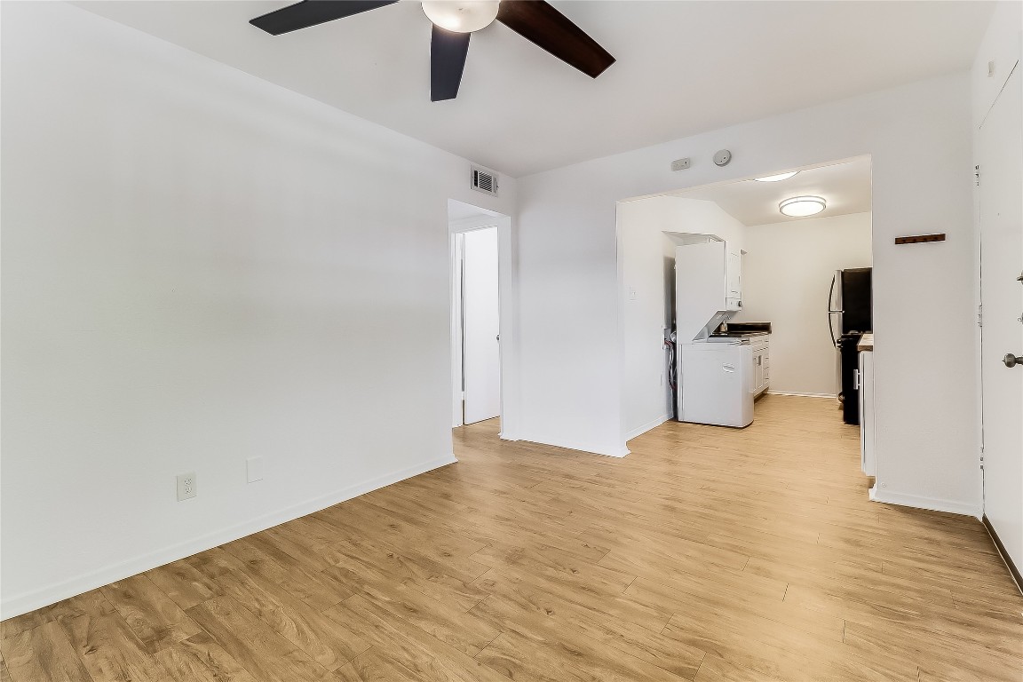 2401 Manor Road, Unit 210 Austin, TX 78722 - Photo 6 of 20 a view of an empty room with a ceiling fan