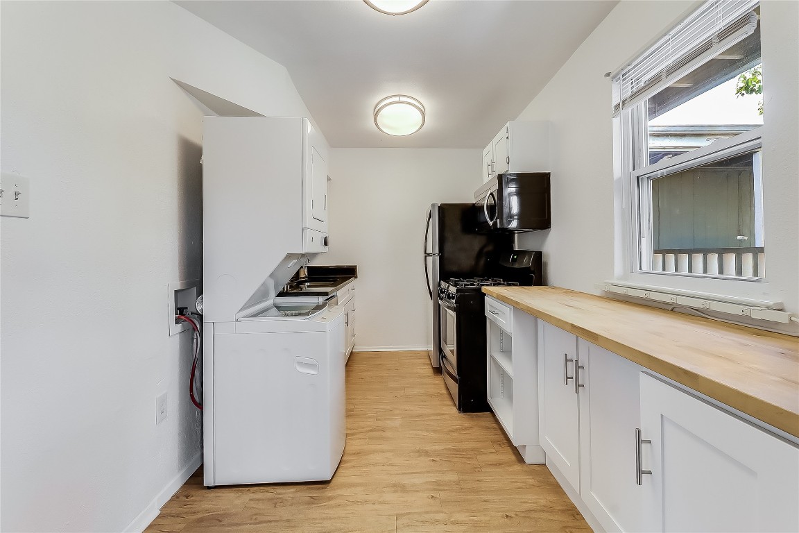 2401 Manor Road, Unit 210 Austin, TX 78722 - Photo 7 of 20 a kitchen with refrigerator and cabinets