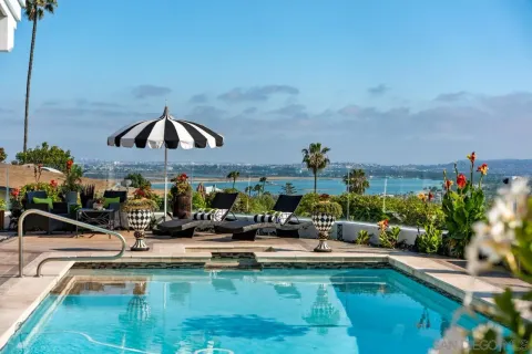 a view of a swimming pool and lounge chairs