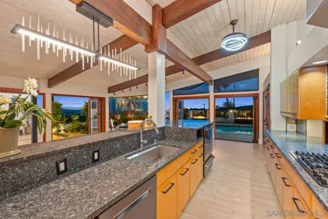 a view of a kitchen with a sink and a large window