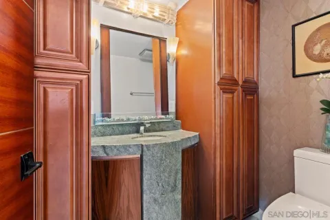 a large bathroom with a granite countertop tub a double vanity sink a mirror and a shower