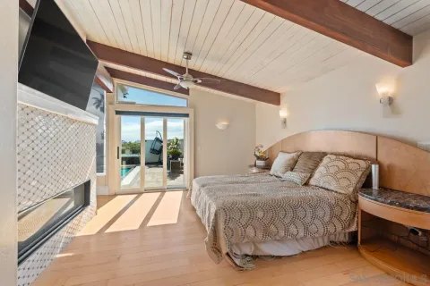 a spacious bedroom with a bed and a chandelier