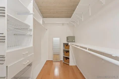 a living room with furniture kitchen view and a large window