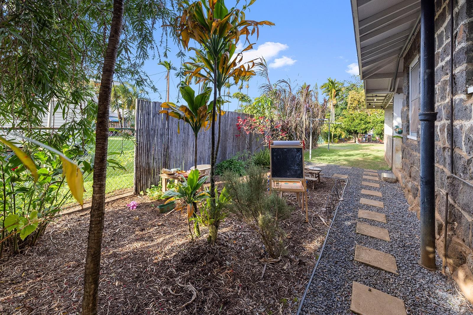 1697 Haiku Road Haiku, HI 96708 - Photo 16 of 48 a view of a garden with plants and a bench