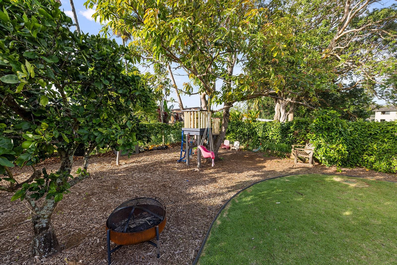 1697 Haiku Road Haiku, HI 96708 - Photo 17 of 48 a backyard of a house with barbeque oven table and chairs