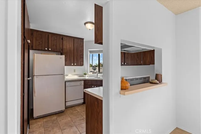 a white refrigerator freezer sitting in a kitchen