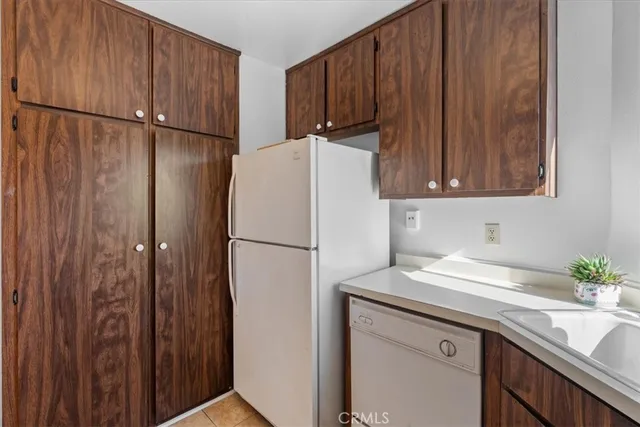 a white refrigerator freezer sitting inside of a kitchen