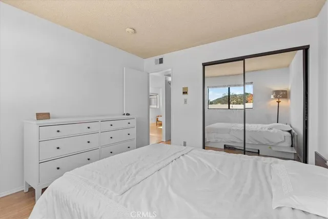 a bedroom with a bed and a mirror