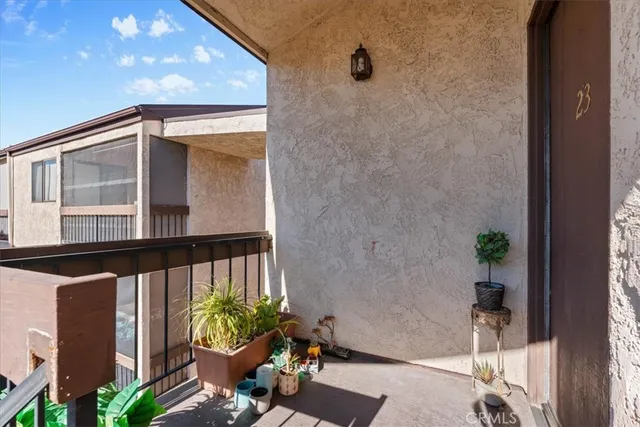a view of a balcony with chair and potted plant