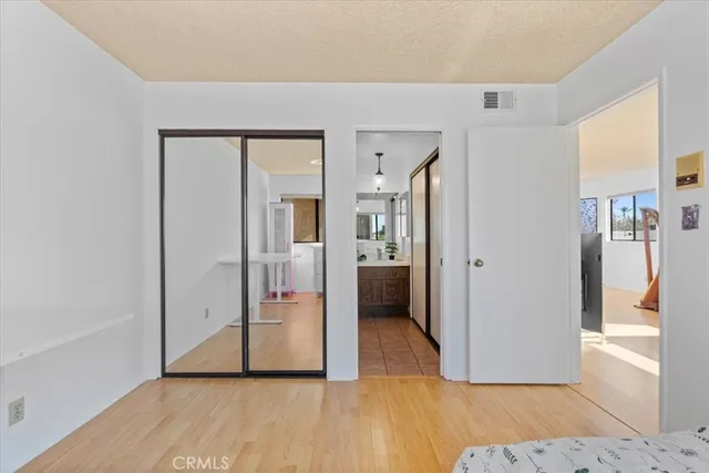a view of a hallway with wooden floor and a living room