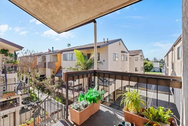 a front view of a house with a potted plant