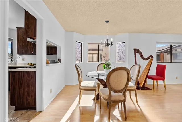 a dining room with furniture a chandelier and wooden floor