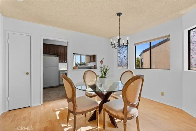 a dining room with furniture a chandelier and window