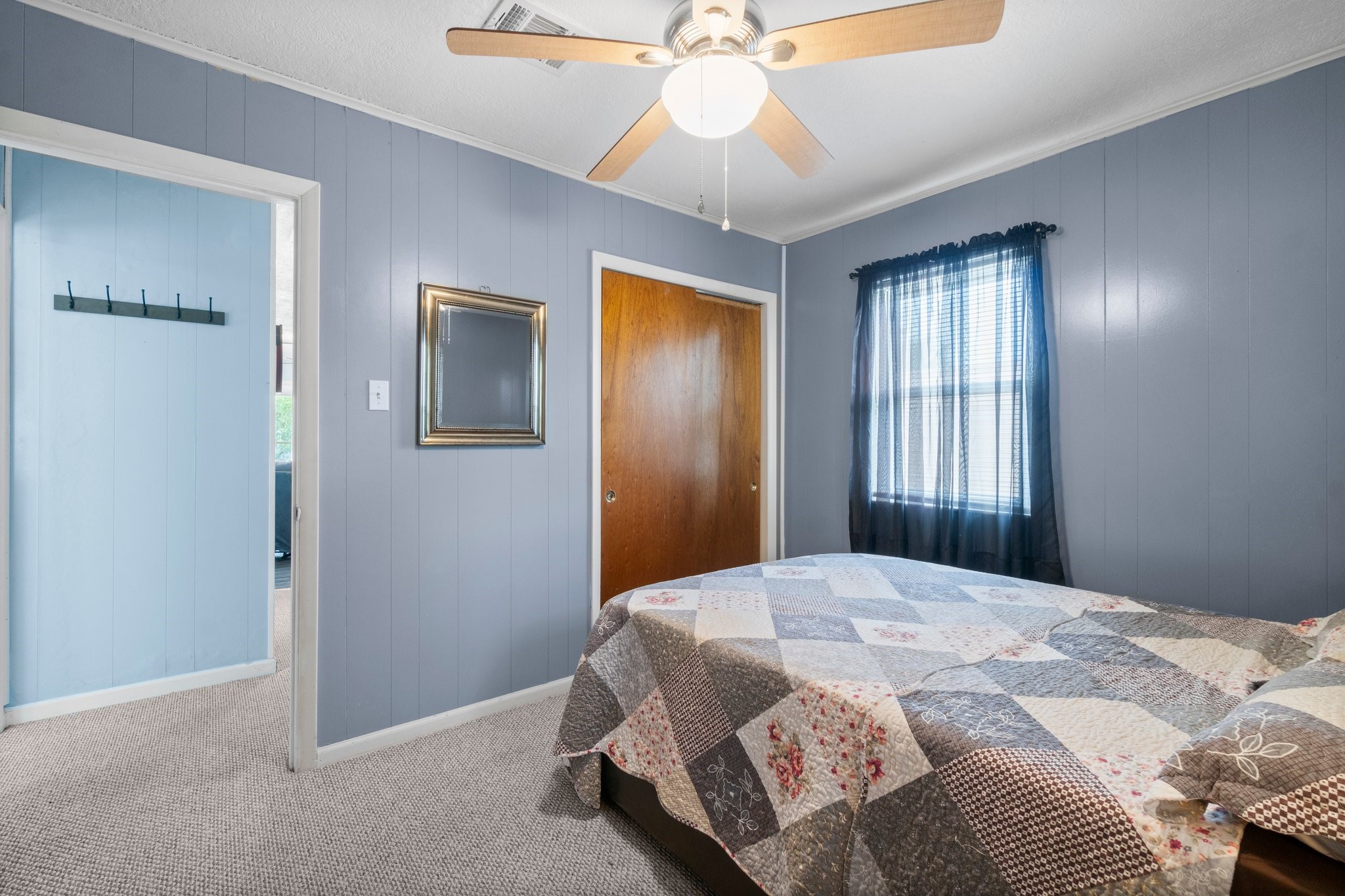 21 Clearview Point Blank, TX 77364 - Photo 23 of 43 a bedroom with a bed and a chandelier
