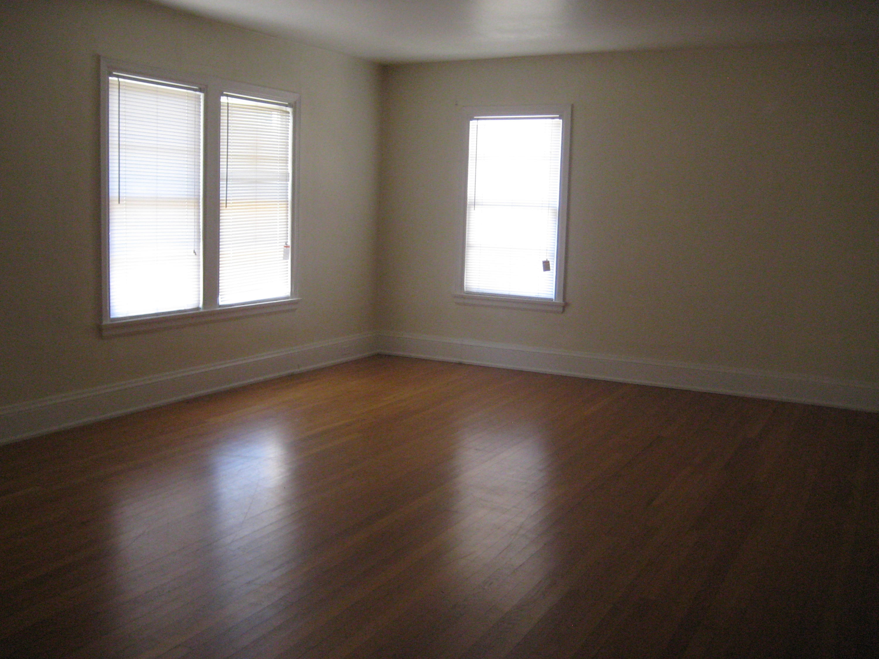 821 North Brett Street Crestview, FL 32536 - Photo 16 of 19 an empty room with wooden floor and windows