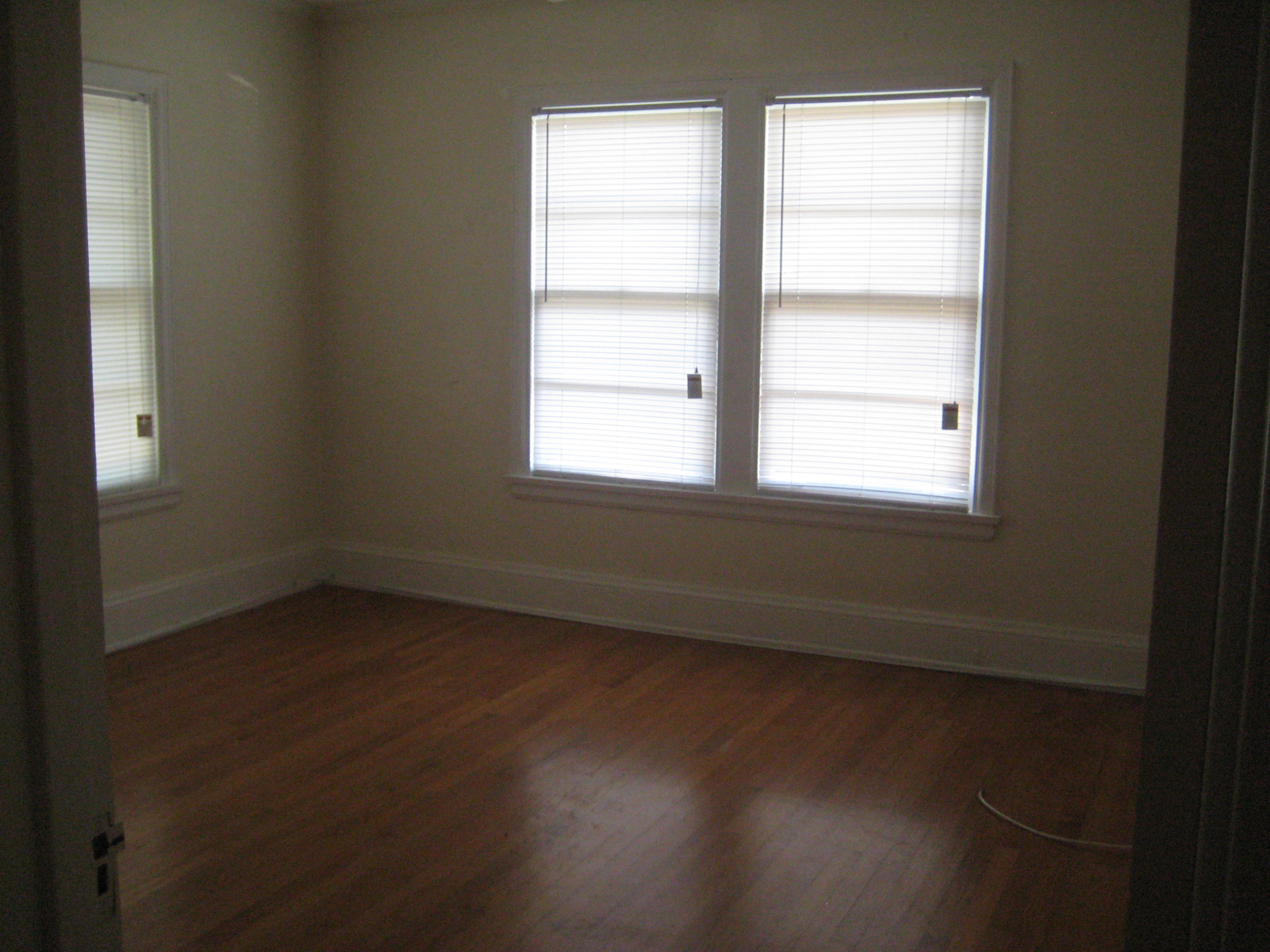 821 North Brett Street Crestview, FL 32536 - Photo 18 of 19 an empty room with wooden floor and windows