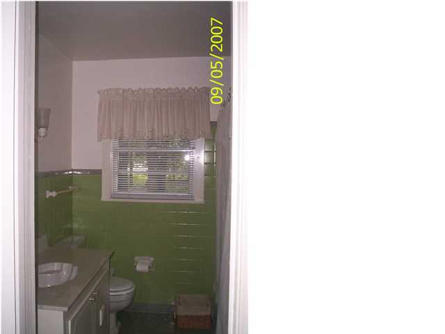821 North Brett Street Crestview, FL 32536 - Photo 4 of 19 a bathroom with a toilet a sink and mirror