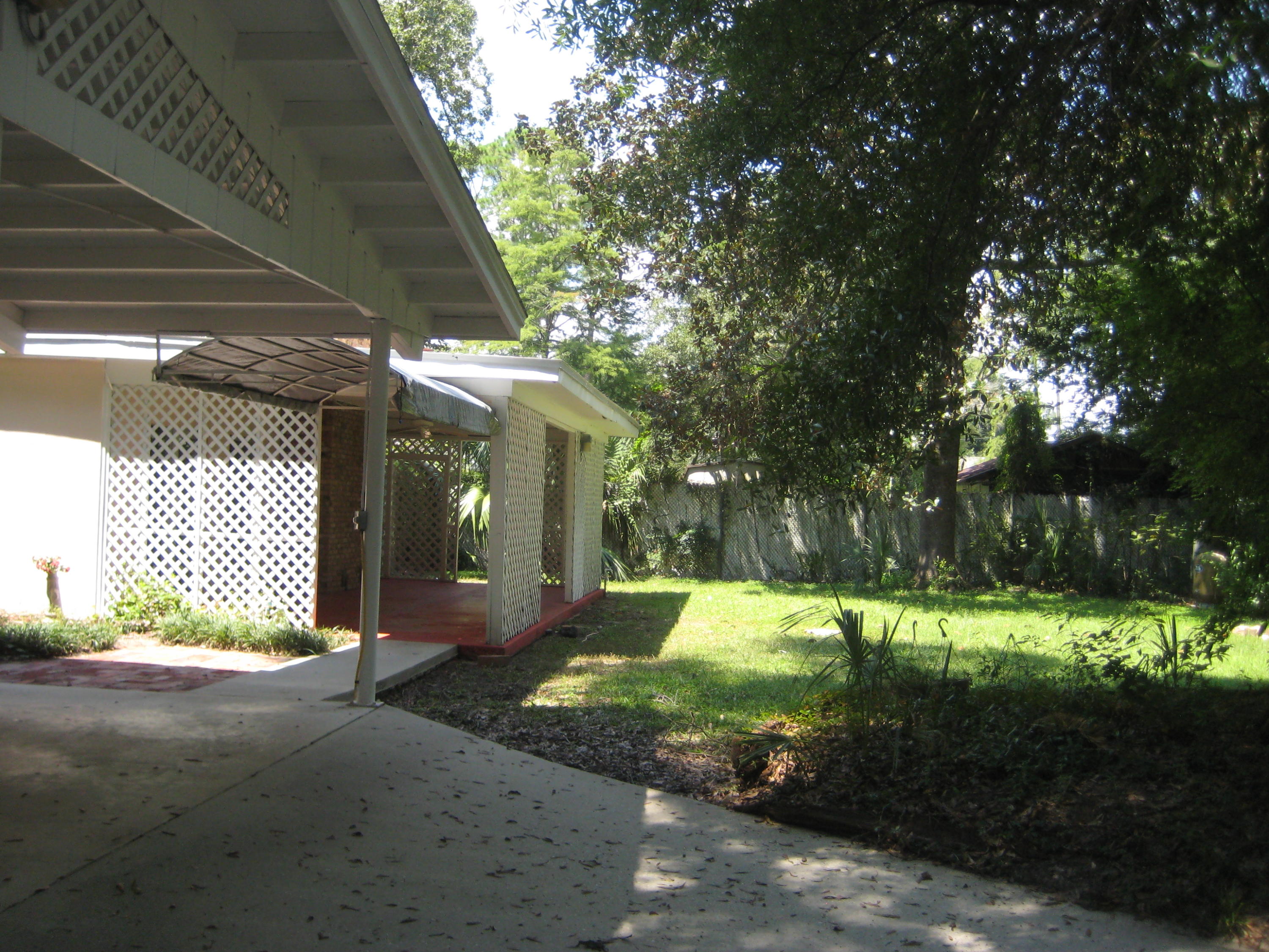 821 North Brett Street Crestview, FL 32536 - Photo 9 of 19 a view of a yard with plants and large tree