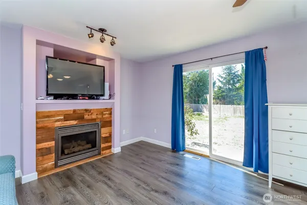 a living room with flat screen tv and a fireplace