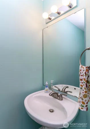 a bathroom with a sink and mirror