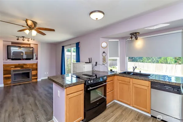 a kitchen with stainless steel appliances a stove a sink and a microwave