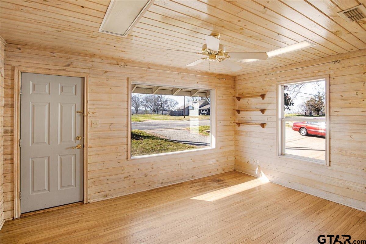 504 Bascom Road Whitehouse, TX 75791 - Photo 5 of 13 an empty room with wooden floor and windows