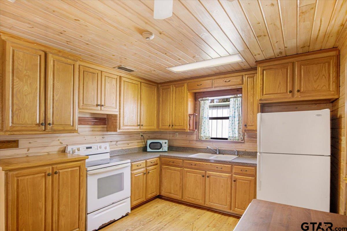 504 Bascom Road Whitehouse, TX 75791 - Photo 7 of 13 a kitchen with granite countertop cabinets stainless steel appliances a sink and a window