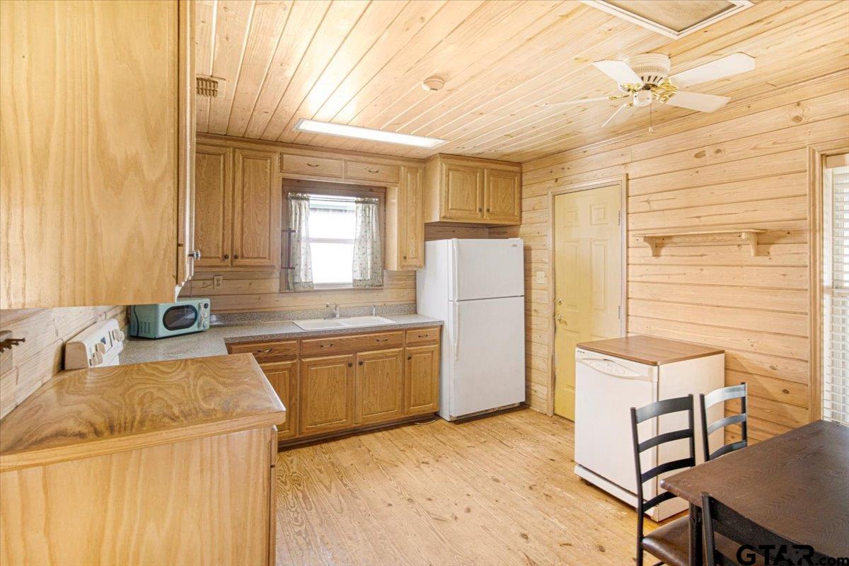 504 Bascom Road Whitehouse, TX 75791 - Photo 8 of 13 a kitchen with stainless steel appliances granite countertop a sink and a refrigerator