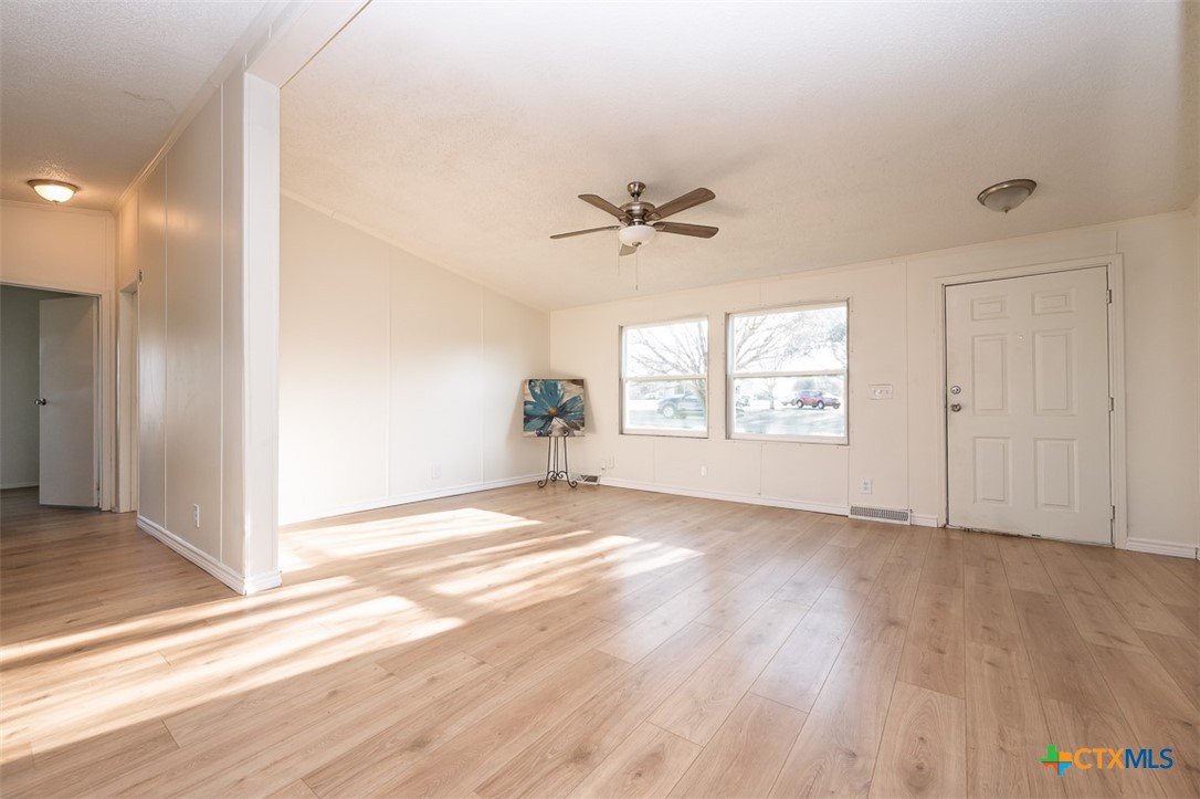 105 Grace Road Belton, TX 76513 - Photo 12 of 25 a view of an empty room with a window and wooden floor