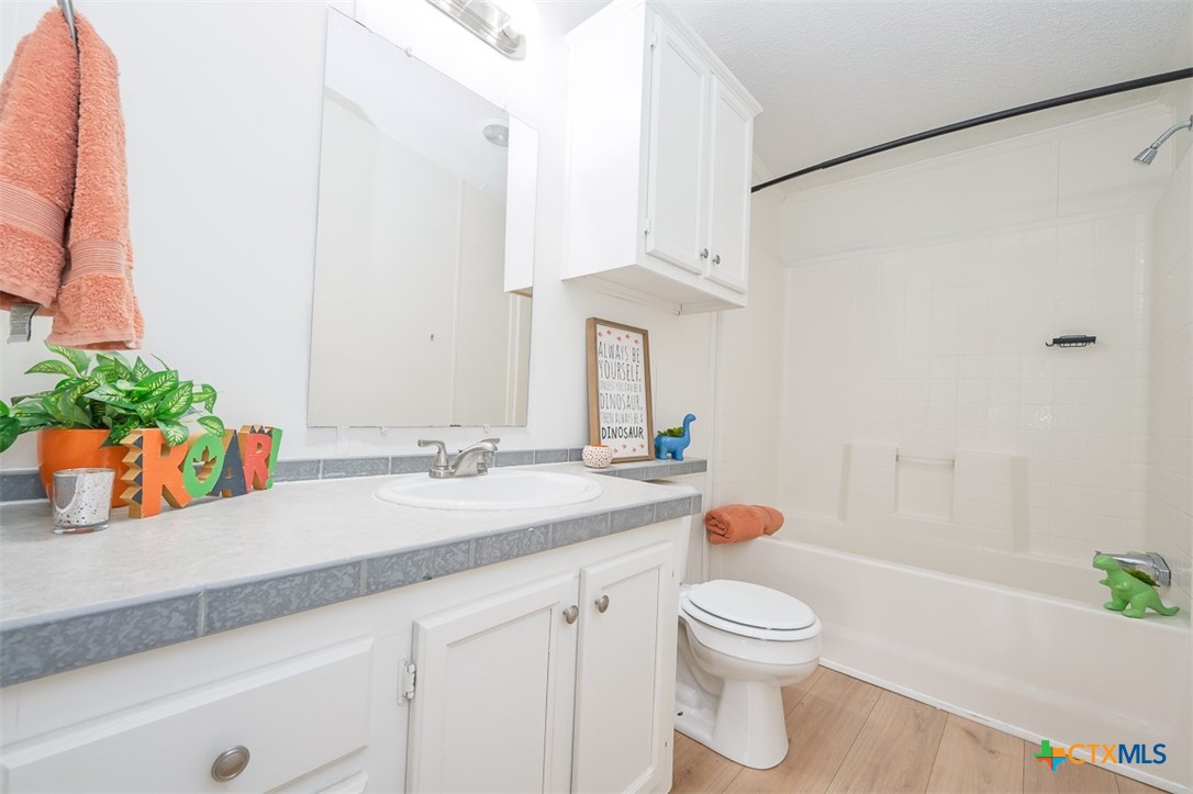 105 Grace Road Belton, TX 76513 - Photo 15 of 25 a bathroom with a granite countertop sink mirror vanity and toilet