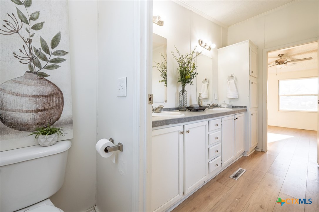 105 Grace Road Belton, TX 76513 - Photo 18 of 25 a bathroom with a granite countertop sink a mirror and a shower