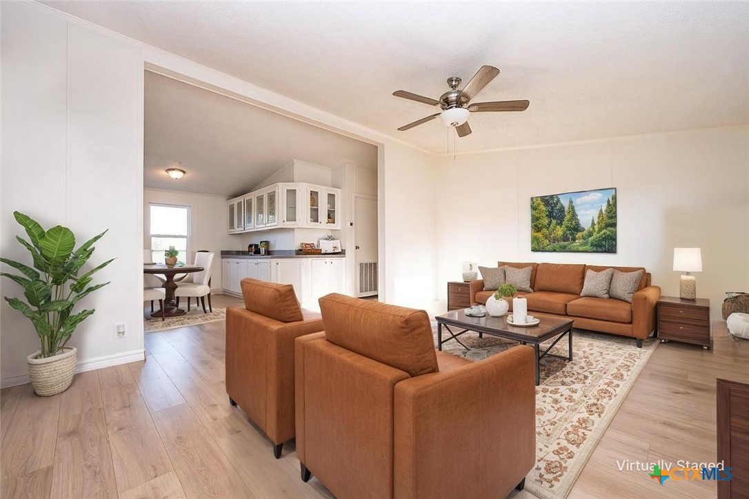 105 Grace Road Belton, TX 76513 - Photo 2 of 25 a living room with furniture and a chandelier