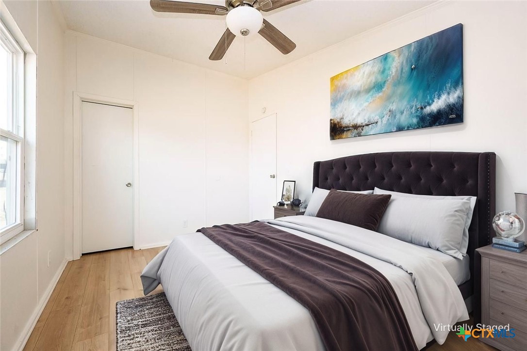 105 Grace Road Belton, TX 76513 - Photo 3 of 25 a bedroom with a bed and wooden floor